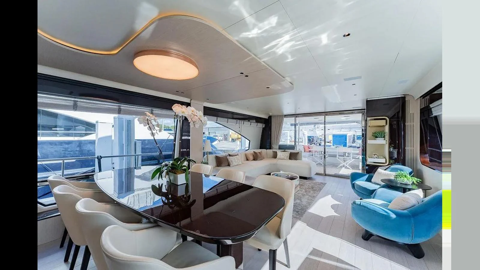 The salon features a modern dining area with plush seating and large windows offering ample natural light. aboard 2022 AZIMUT GRANDE 25 METRI Yacht for Sale
