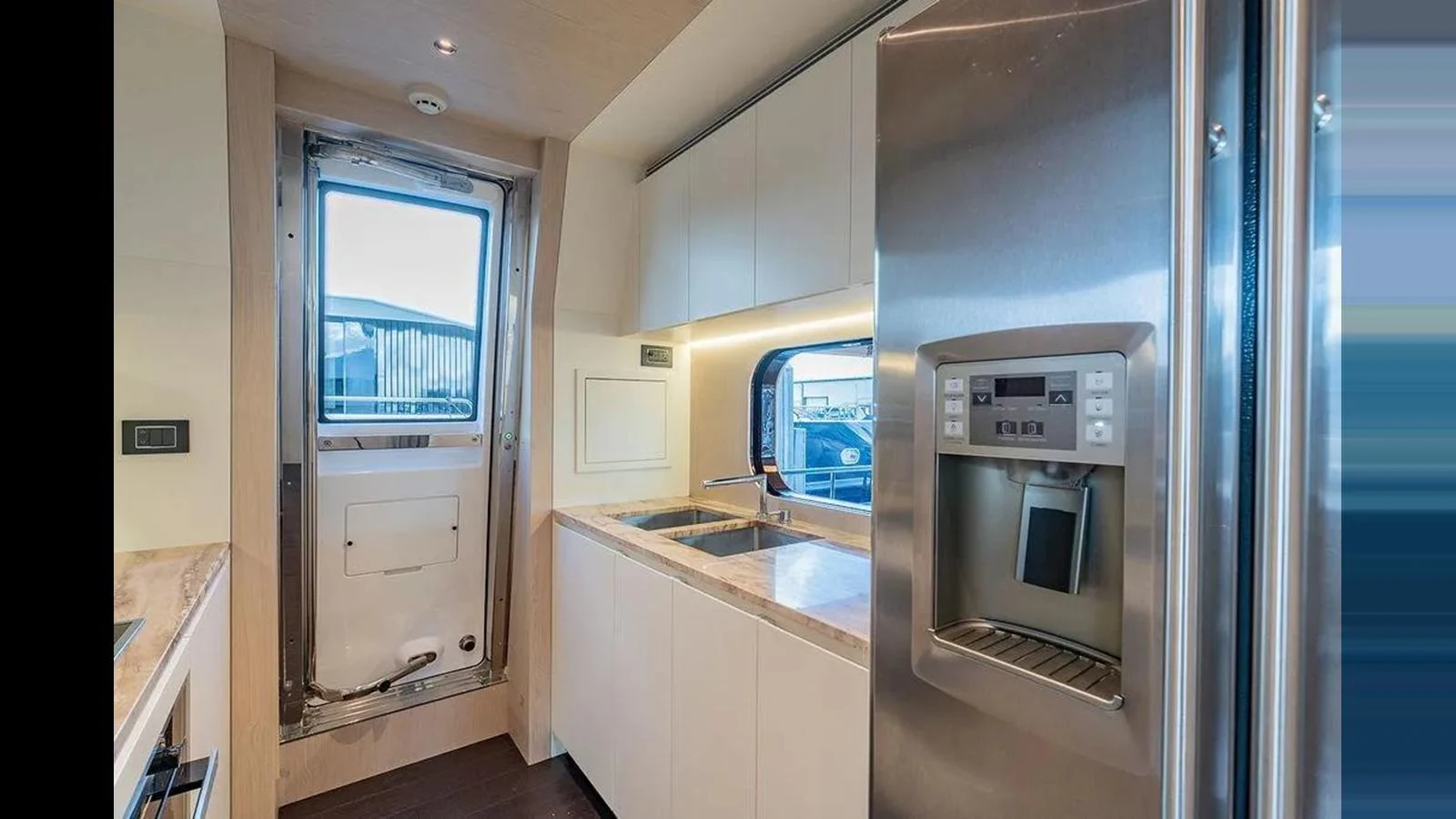 The yacht's galley features modern appliances and sleek cabinetry, offering a functional and stylish space for meal preparation. aboard 2022 AZIMUT GRANDE 25 METRI Yacht for Sale