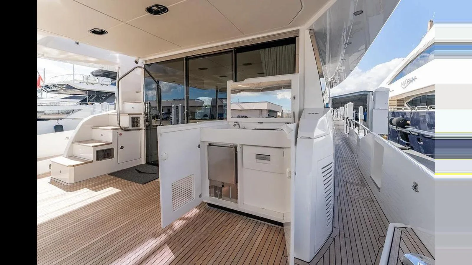 The aft deck features a sleek, modern design with ample space and a built-in outdoor kitchen. aboard 2022 AZIMUT GRANDE 25 METRI Yacht for Sale