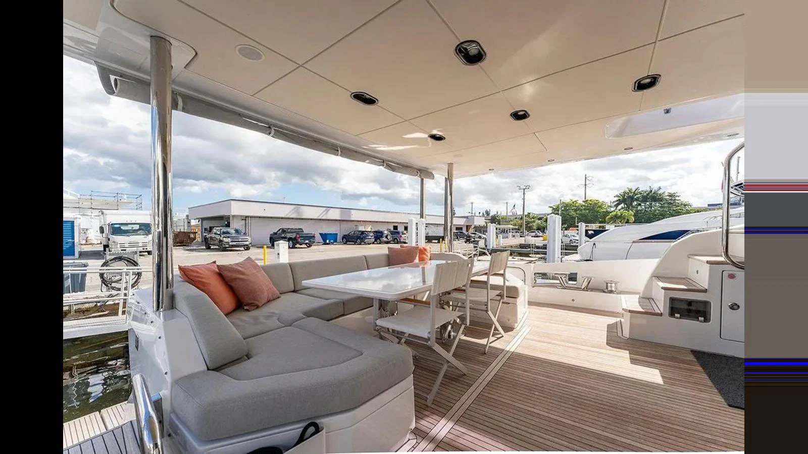 The aft deck features a comfortable seating area with a dining table, perfect for outdoor relaxation and meals. aboard 2022 AZIMUT GRANDE 25 METRI Yacht for Sale