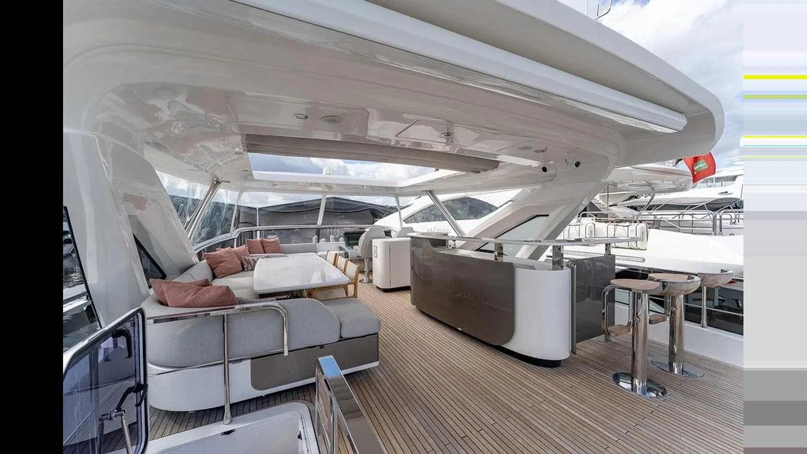 The flybridge offers a spacious and luxurious outdoor lounging area with ample seating and a sleek bar. aboard 2022 AZIMUT GRANDE 25 METRI Yacht for Sale