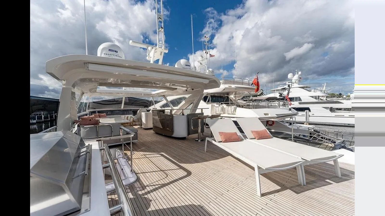 The flybridge offers spacious lounging areas with sunbeds and seating under a sleek canopy. aboard 2022 AZIMUT GRANDE 25 METRI Yacht for Sale