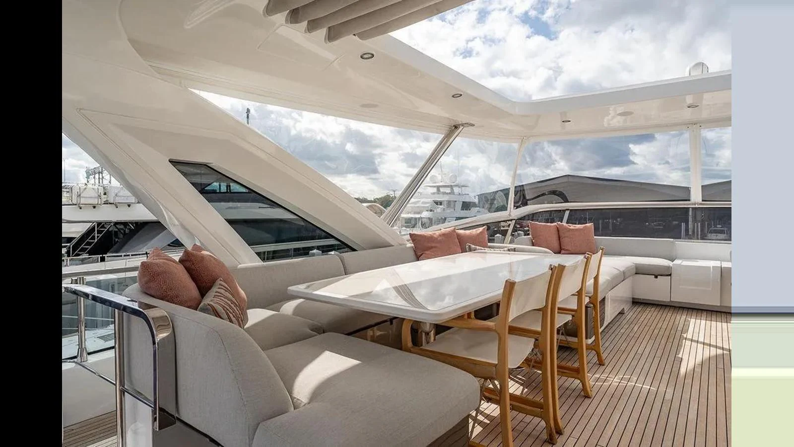 The aft deck features a spacious seating area with a large dining table, perfect for outdoor gatherings. aboard 2022 AZIMUT GRANDE 25 METRI Yacht for Sale