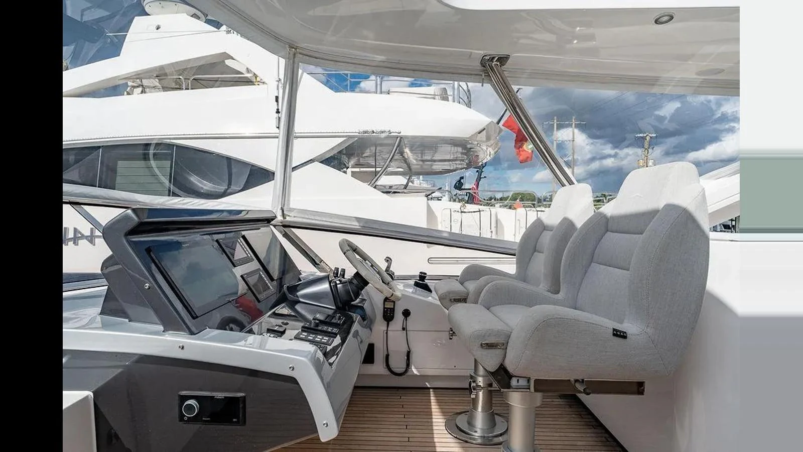 The helm station features modern navigation equipment and comfortable seating, offering a commanding view for the captain. aboard 2022 AZIMUT GRANDE 25 METRI Yacht for Sale