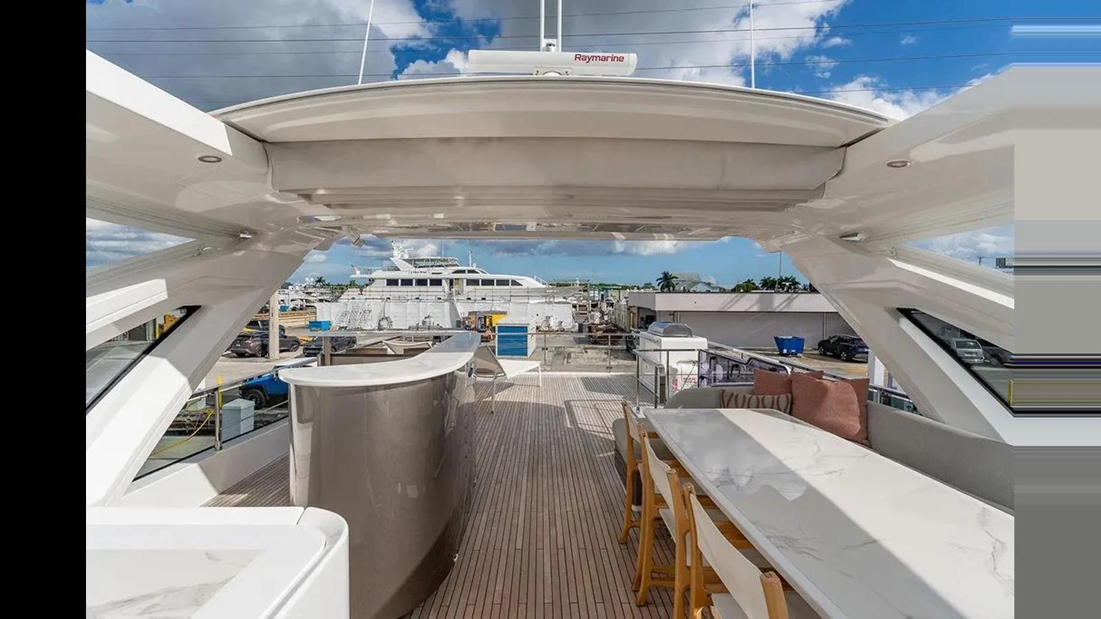 The flybridge offers a spacious and luxurious outdoor area with ample seating and a bar for entertainment. aboard 2022 AZIMUT GRANDE 25 METRI Yacht for Sale