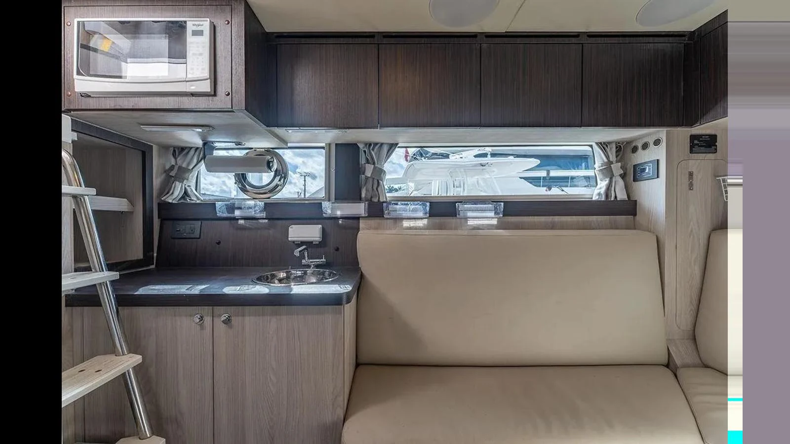The yacht's galley features a compact and efficient layout with modern appliances and comfortable seating. aboard 2022 AZIMUT GRANDE 25 METRI Yacht for Sale
