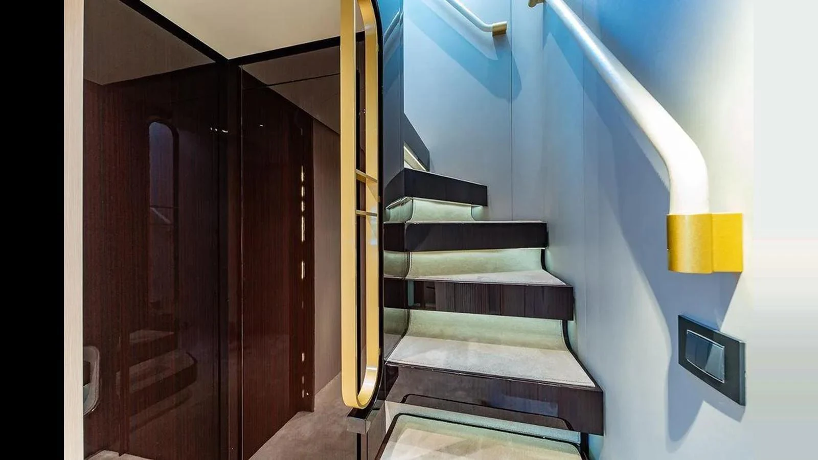 A modern staircase with sleek design elements inside the yacht. aboard 2022 AZIMUT GRANDE 25 METRI Yacht for Sale