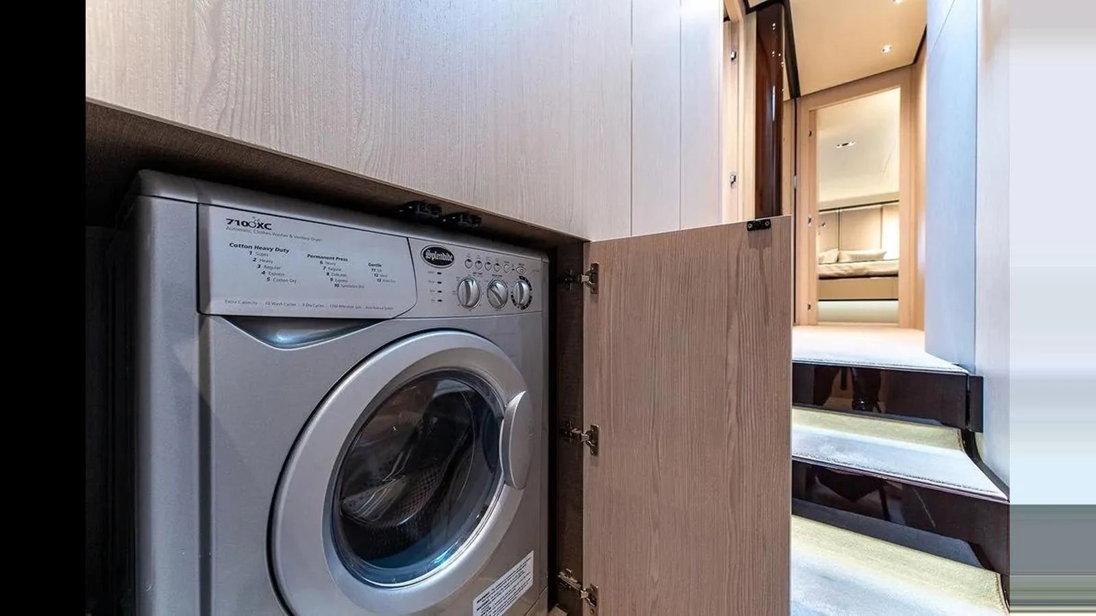 The yacht features a convenient laundry area with a washing machine, seamlessly integrated into the interior design. aboard 2022 AZIMUT GRANDE 25 METRI Yacht for Sale