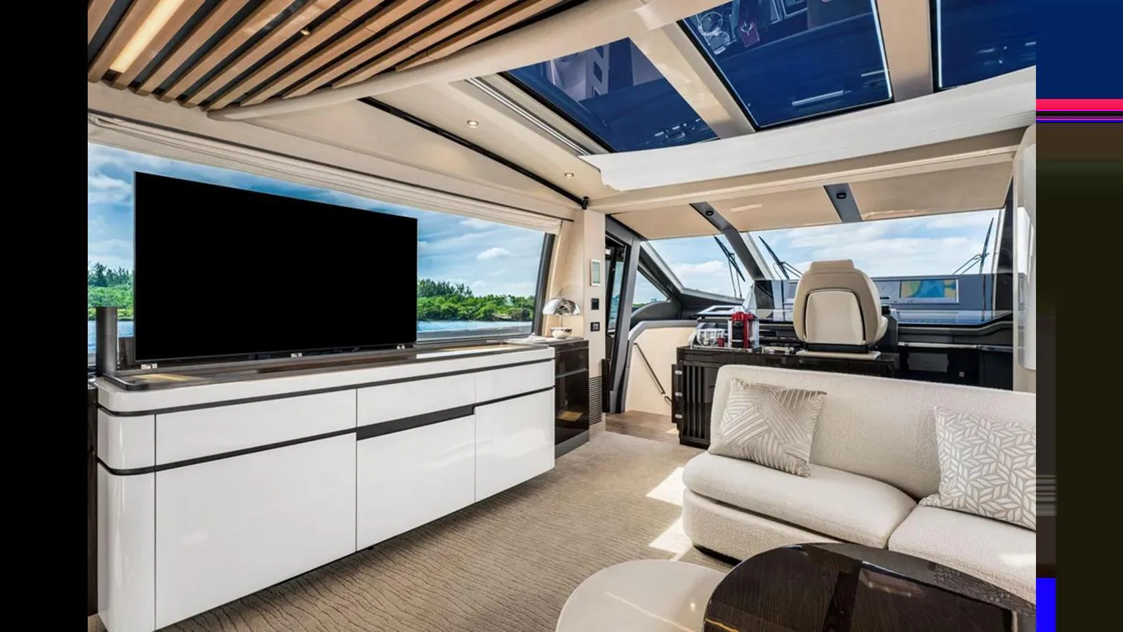 The salon features modern furnishings with a large TV and ample natural light. aboard 2022 AZIMUT S10 Yacht for Sale