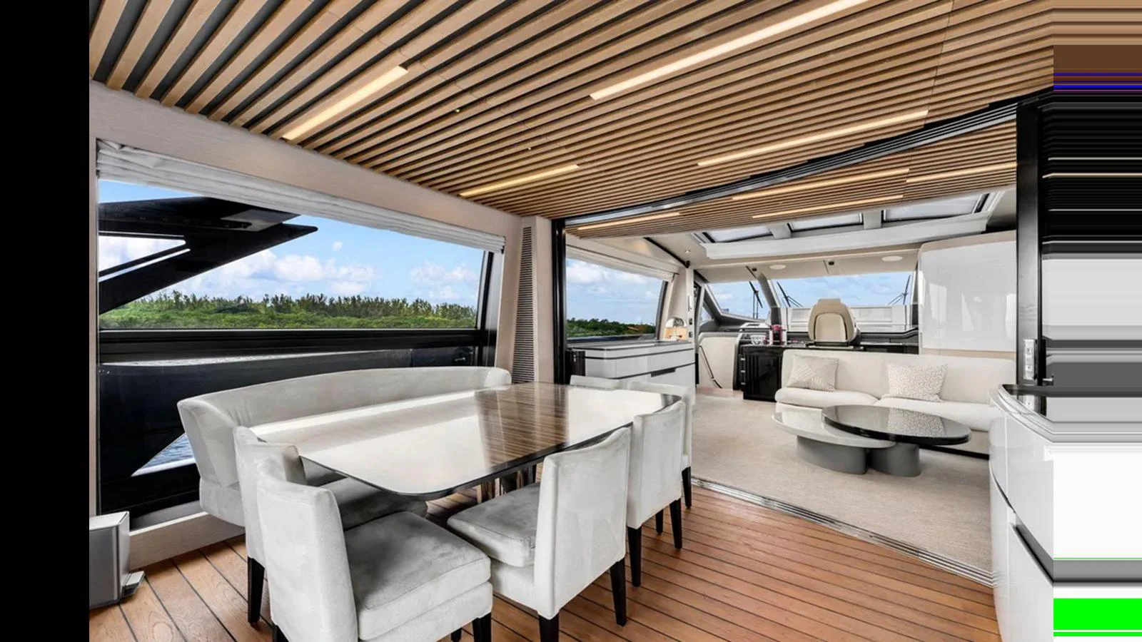 The yacht's salon features a spacious dining area with a modern table and plush seating, complemented by large windows and a sleek ceiling design. aboard 2022 AZIMUT S10 Yacht for Sale