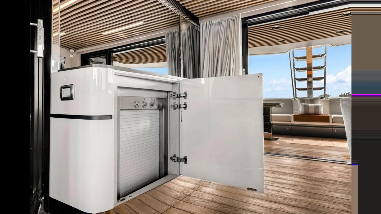 This image showcases a modern galley area with an open refrigerator and a view of the deck. aboard 2022 AZIMUT S10 Yacht for Sale