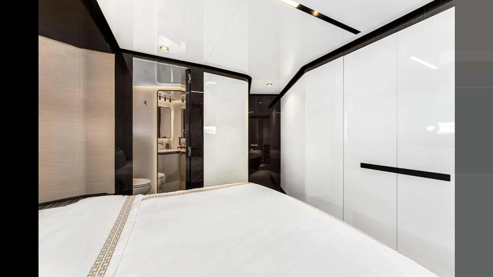 The stateroom features sleek, modern design with glossy white cabinetry and luxurious bedding. aboard 2022 AZIMUT S10 Yacht for Sale