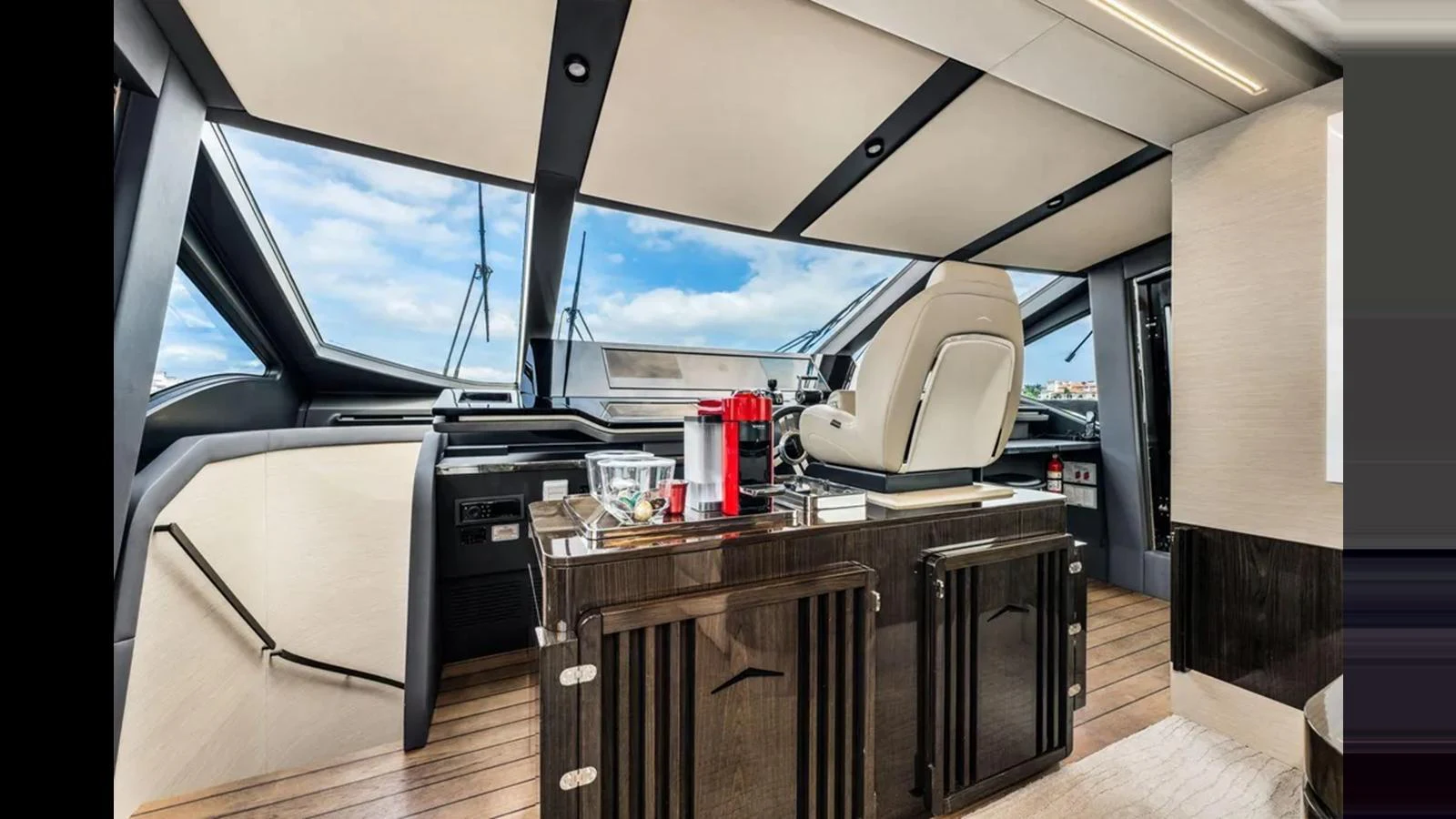 The helm station features modern controls and luxurious finishes, offering panoramic views through large windows. aboard 2022 AZIMUT S10 Yacht for Sale