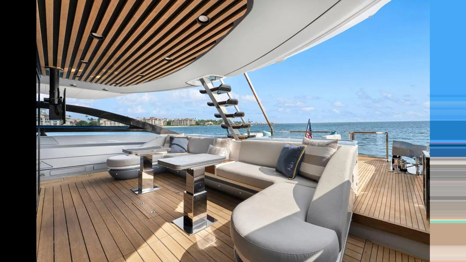 The aft deck features a stylish seating area with modern furnishings and a stunning ocean view. aboard 2022 AZIMUT S10 Yacht for Sale