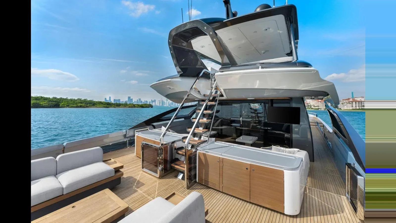 The yacht's aft deck features a spacious lounging area with modern furnishings and a sleek staircase leading to the upper deck. aboard 2022 AZIMUT S10 Yacht for Sale