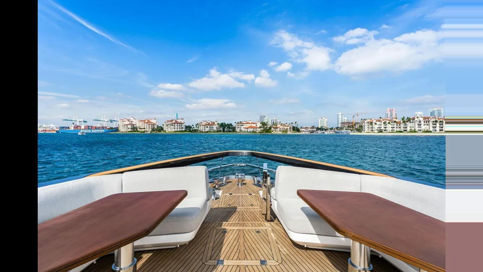 The foredeck offers a spacious seating area with stunning views of the water and cityscape. aboard 2022 AZIMUT S10 Yacht for Sale