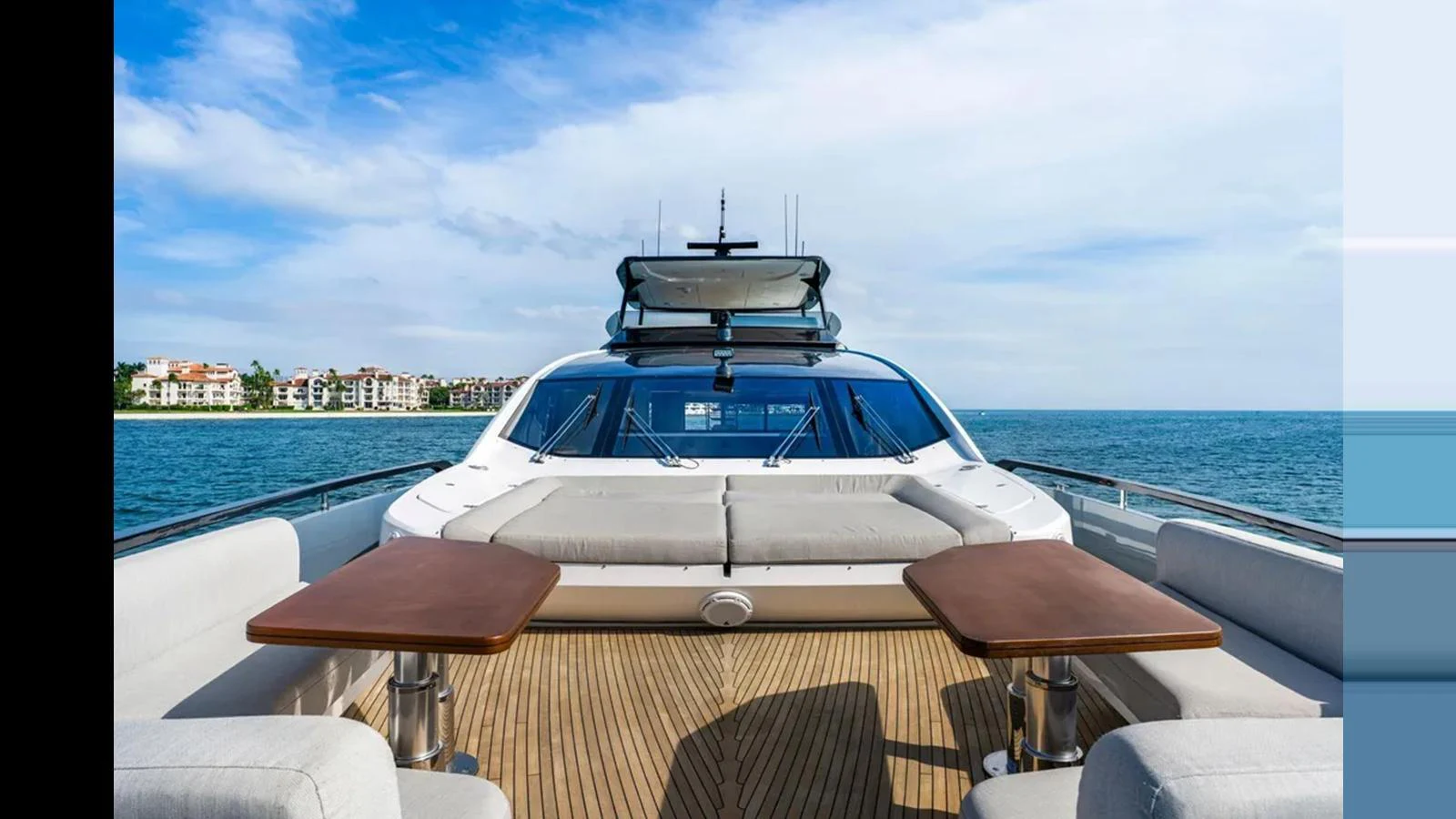 The foredeck offers a spacious seating area with two tables, perfect for enjoying the ocean views. aboard 2022 AZIMUT S10 Yacht for Sale