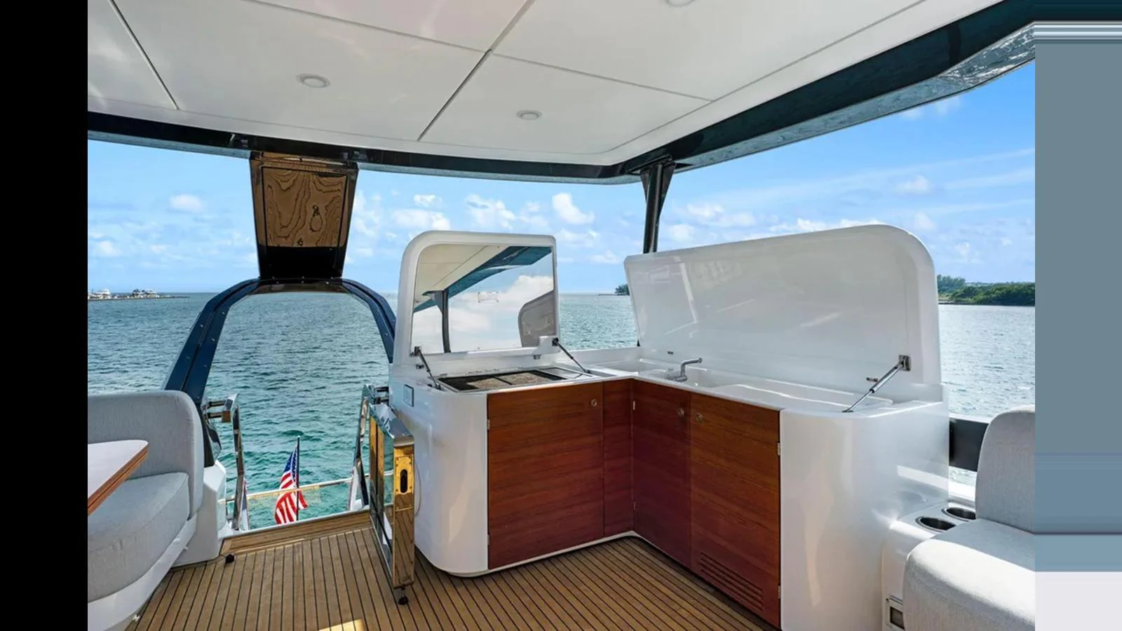 The aft deck features a spacious and modern outdoor kitchen area with stunning sea views. aboard 2022 AZIMUT S10 Yacht for Sale
