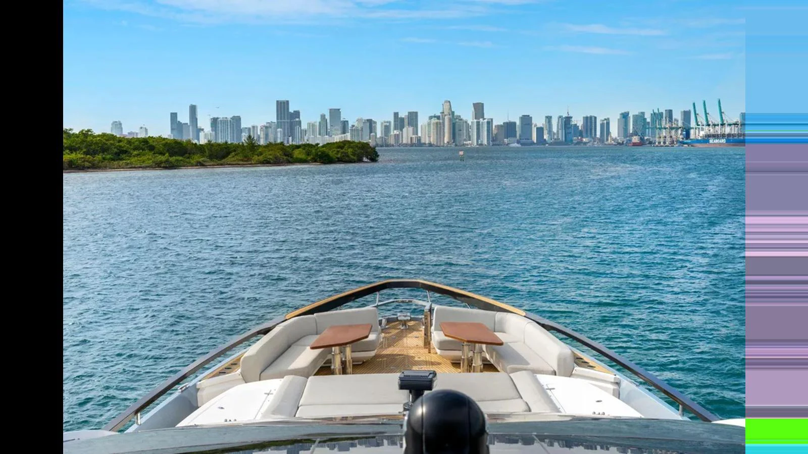 The yacht's bow offers a stunning view of the city skyline across the water. aboard 2022 AZIMUT S10 Yacht for Sale