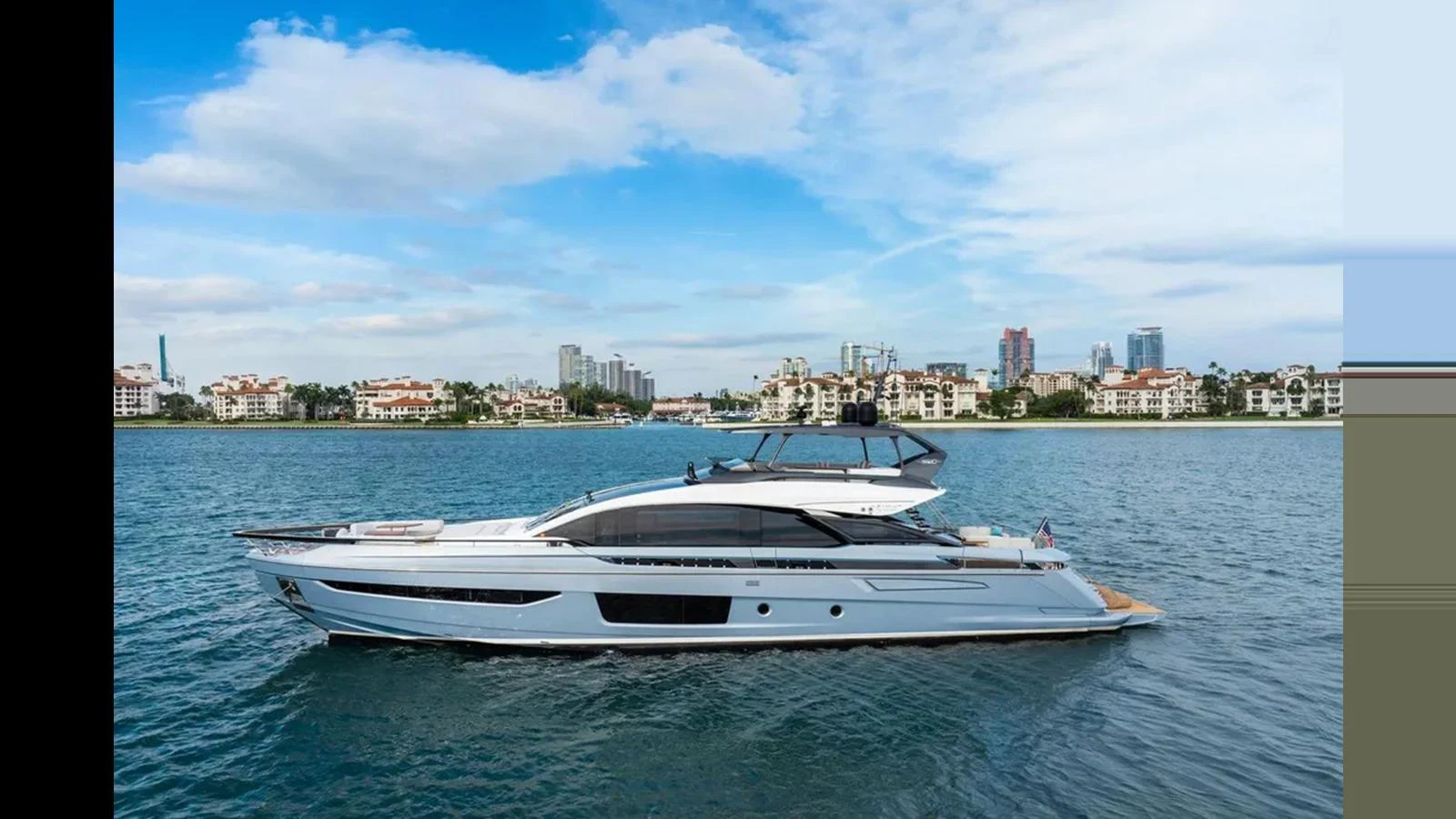 A sleek yacht glides through calm waters with a cityscape in the background. aboard 2022 AZIMUT S10 Yacht for Sale