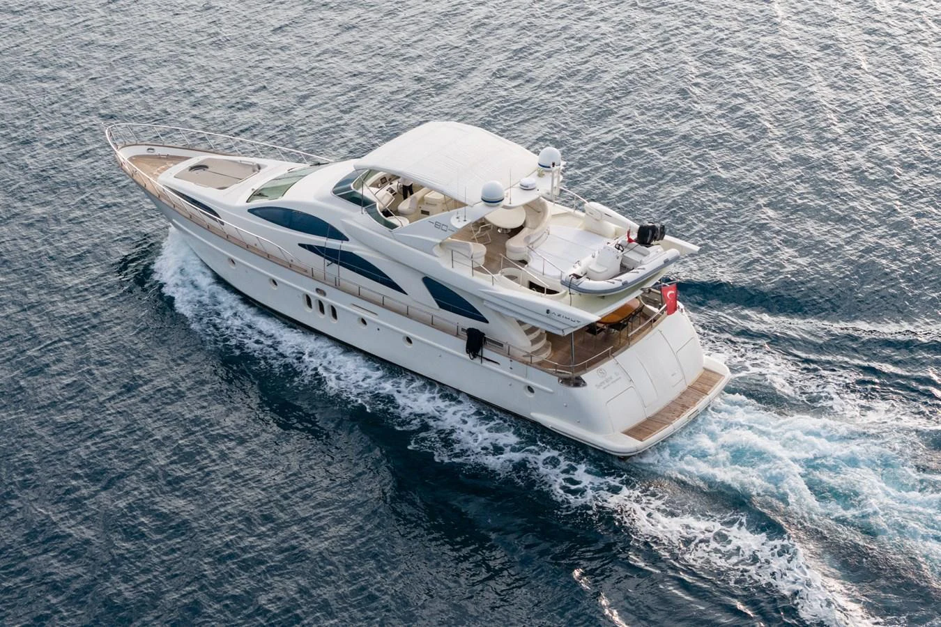 A luxurious yacht glides smoothly over the water, showcasing its elegant design and spacious decks. aboard SENIOR S Yacht for Sale