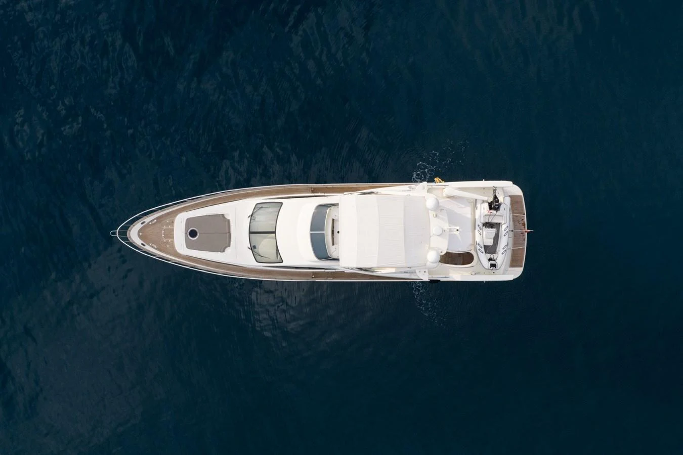 Aerial view of a sleek yacht cruising on calm waters. aboard SENIOR S Yacht for Sale