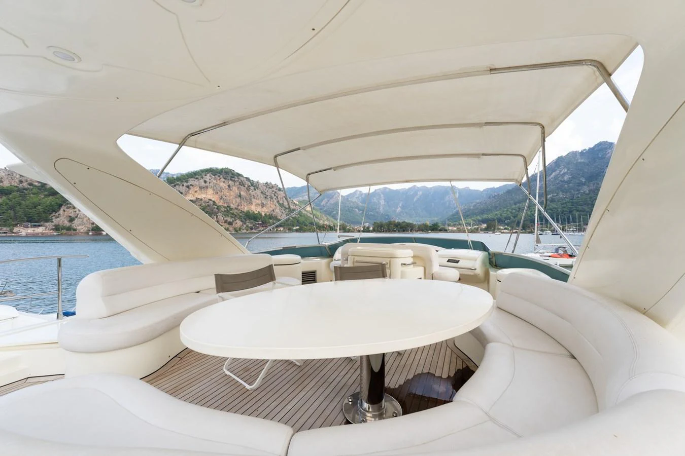 The flybridge offers a spacious seating area with a large table, perfect for enjoying scenic views. aboard SENIOR S Yacht for Sale