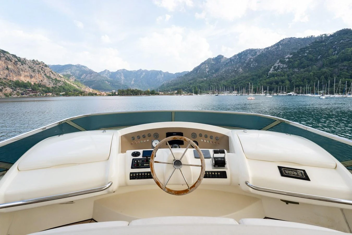 The helm offers a commanding view of the serene waters and distant mountains. aboard SENIOR S Yacht for Sale