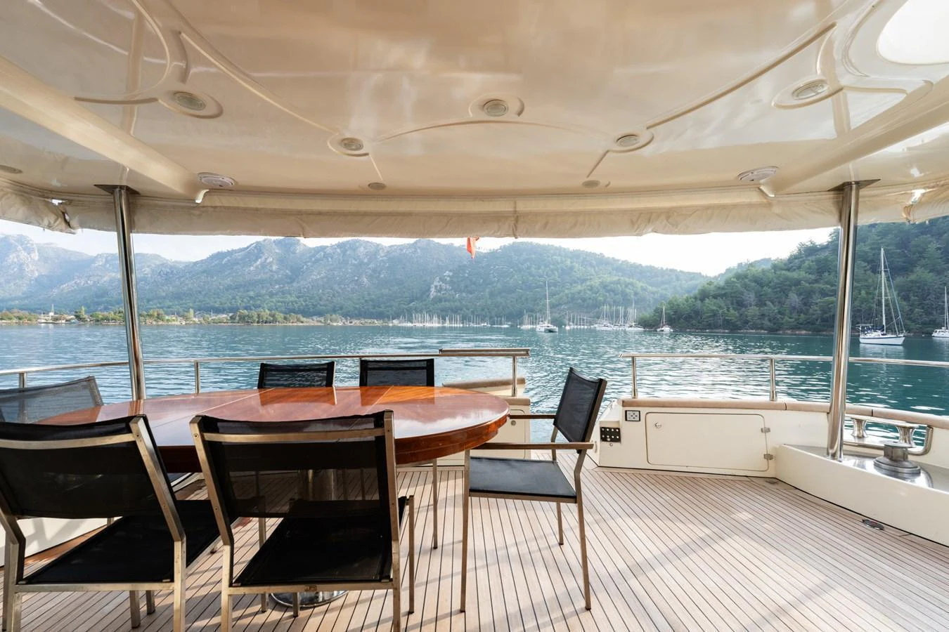 The aft deck features a stylish dining area with a stunning view of the surrounding waters and mountains. aboard SENIOR S Yacht for Sale
