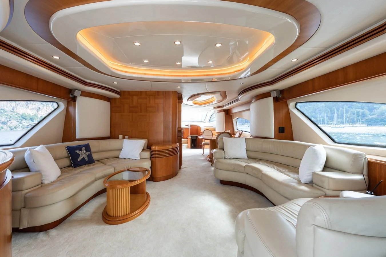 The salon features luxurious seating with ample natural light and elegant wood finishes. aboard SENIOR S Yacht for Sale
