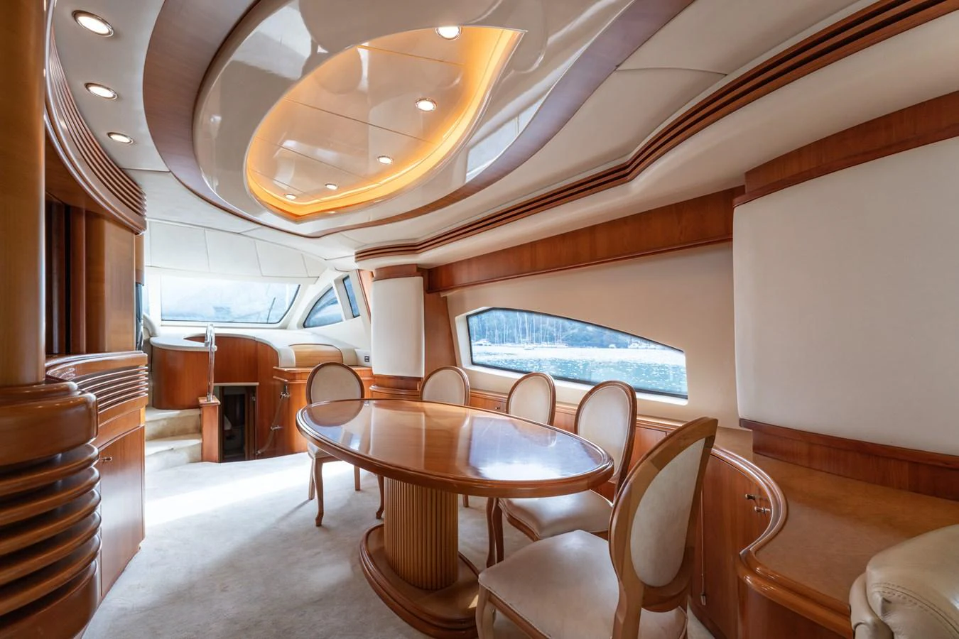 The yacht's dining area features elegant wood finishes and ample natural light. aboard SENIOR S Yacht for Sale