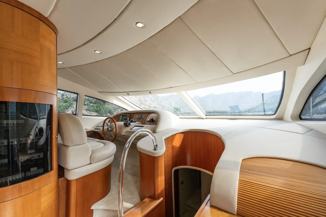 The helm station features luxurious wood finishes and panoramic windows offering stunning views. aboard SENIOR S Yacht for Sale
