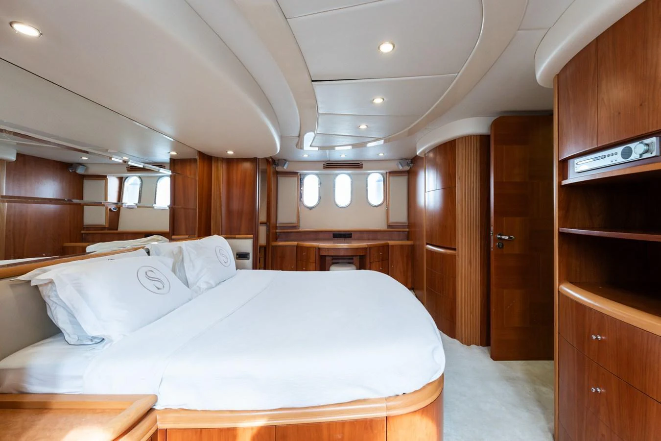 The master stateroom features elegant wood paneling and a spacious bed, creating a luxurious and inviting atmosphere. aboard SENIOR S Yacht for Sale