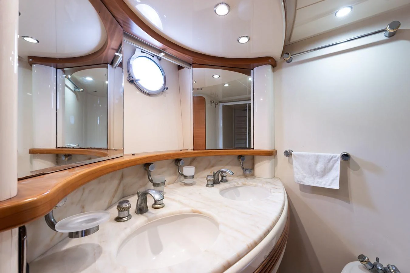 The yacht's bathroom features a double sink vanity with elegant fixtures and ample lighting. aboard SENIOR S Yacht for Sale