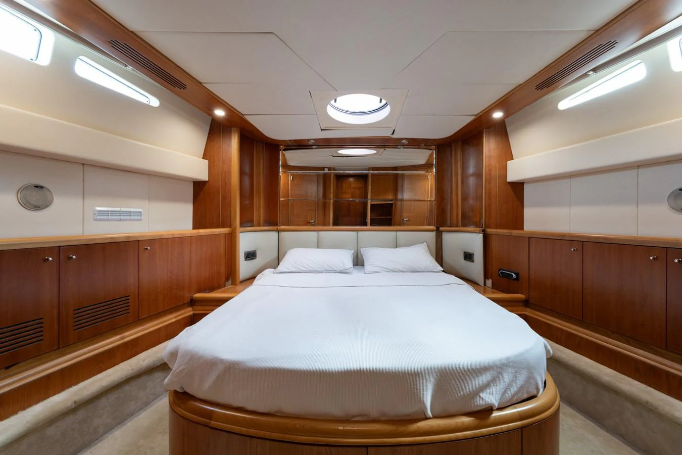 The master stateroom features a luxurious double bed with ample storage and elegant wood paneling. aboard SENIOR S Yacht for Sale