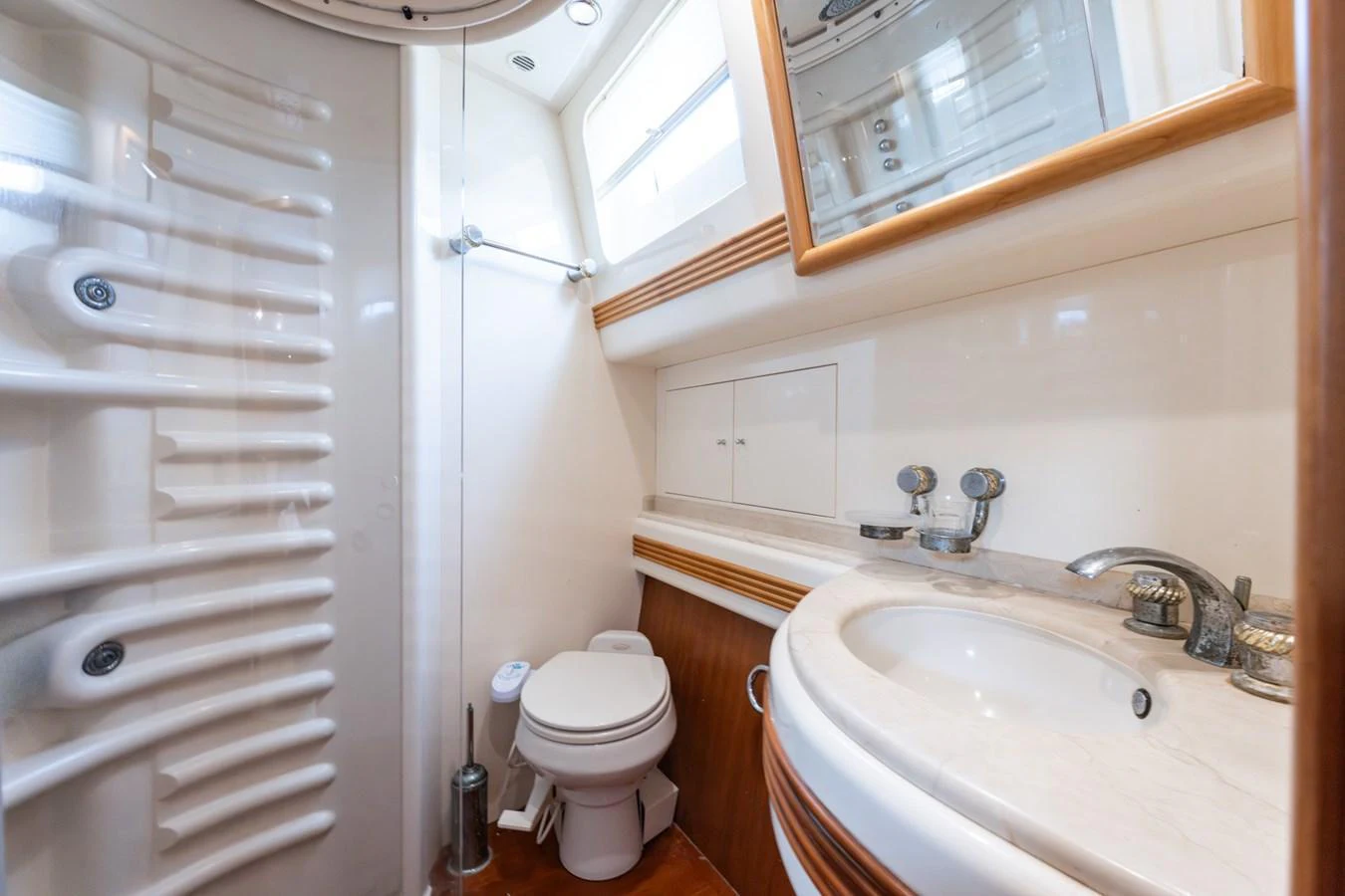 The yacht's bathroom features a sleek design with modern fixtures and ample lighting. aboard SENIOR S Yacht for Sale