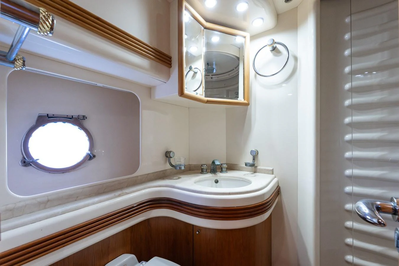 The yacht's bathroom features elegant wood accents and modern fixtures. aboard SENIOR S Yacht for Sale
