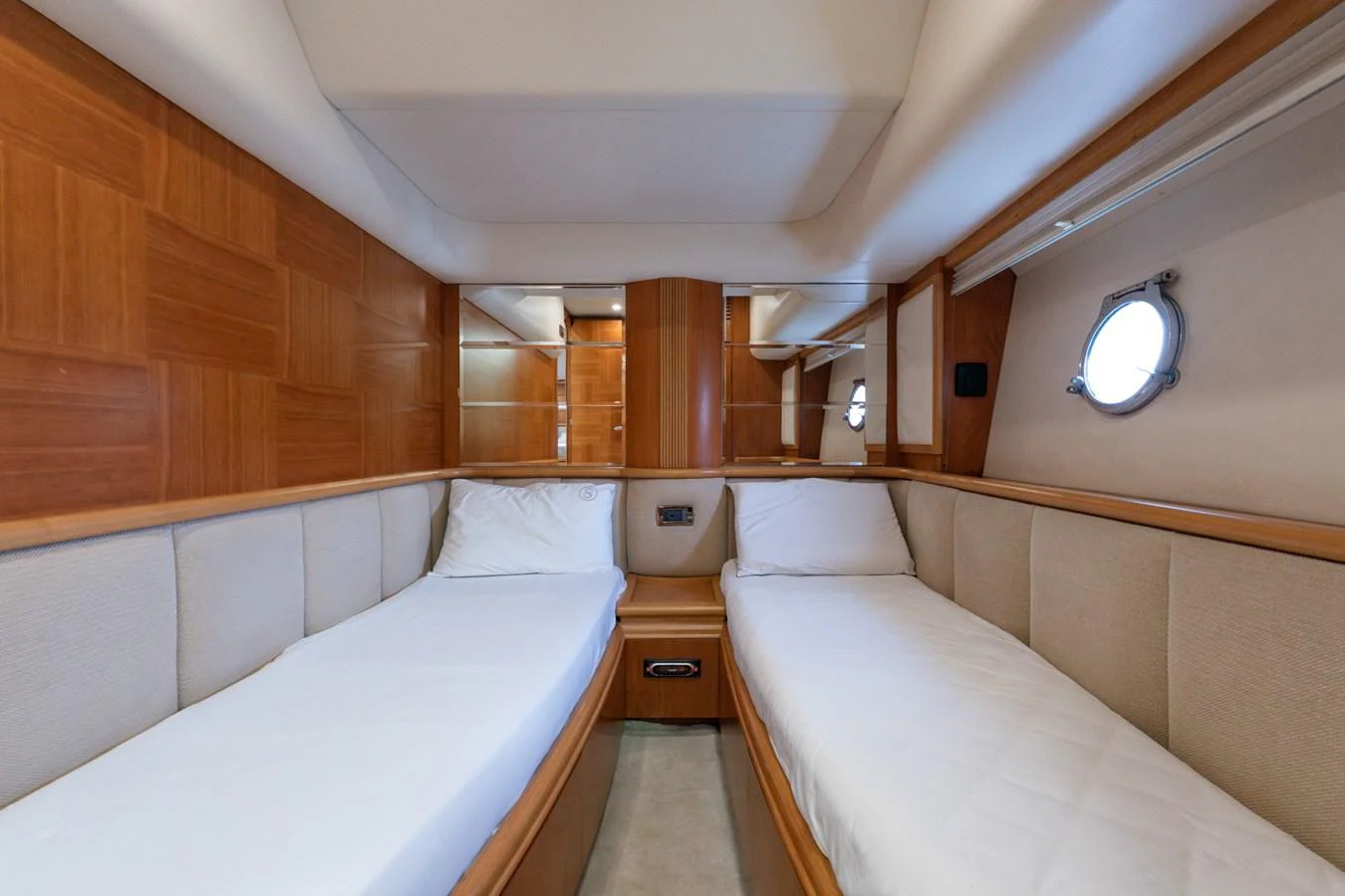 The twin cabin features two single beds with plush bedding and wooden accents, offering a cozy and elegant retreat. aboard SENIOR S Yacht for Sale