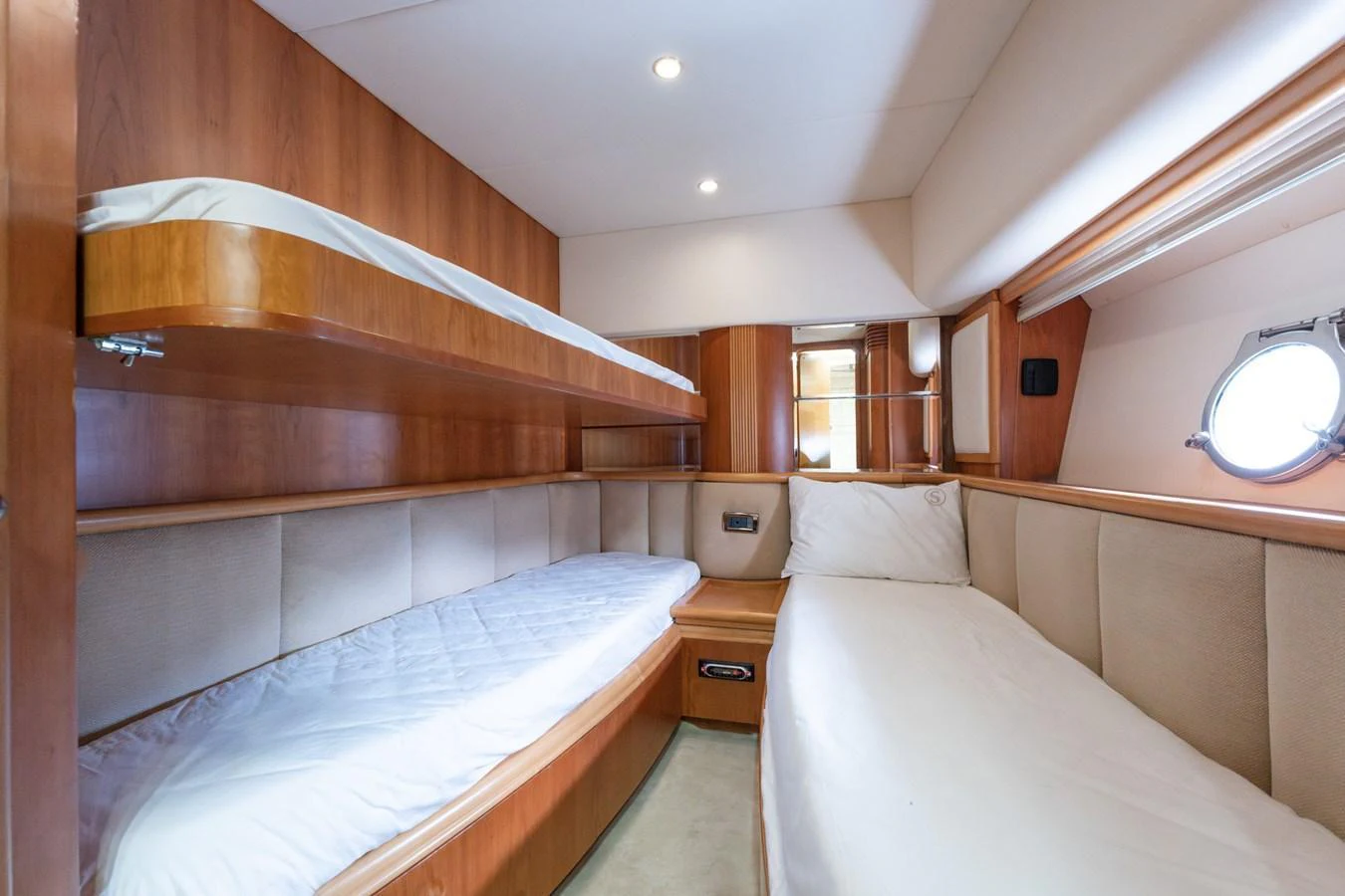 The guest cabin features twin beds with warm wood finishes and ample natural light. aboard SENIOR S Yacht for Sale