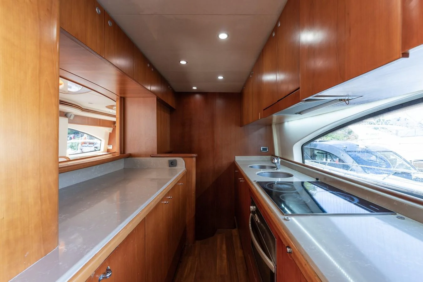 The galley features sleek wooden cabinetry and modern appliances, offering a functional and stylish cooking space. aboard SENIOR S Yacht for Sale