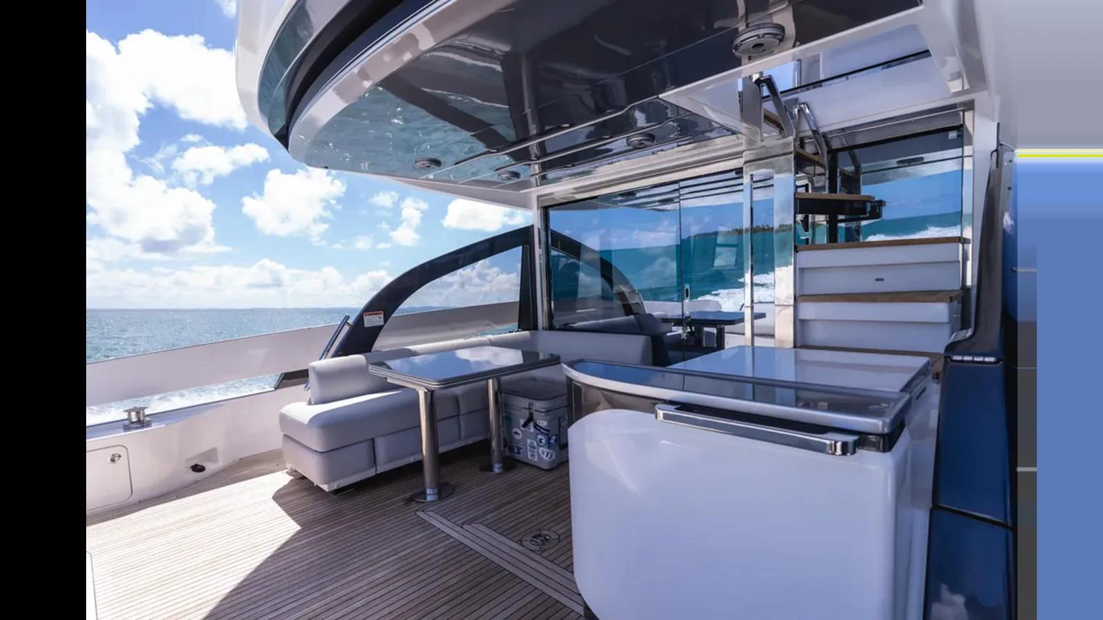 The aft deck offers a luxurious outdoor seating area with modern furnishings and stunning ocean views. aboard AZIMUT S7 Yacht for Sale