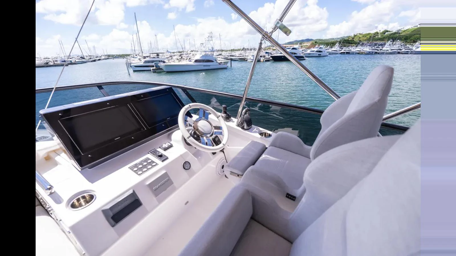 The helm station offers a commanding view of the marina, with state-of-the-art navigation equipment and plush seating. aboard AZIMUT S7 Yacht for Sale
