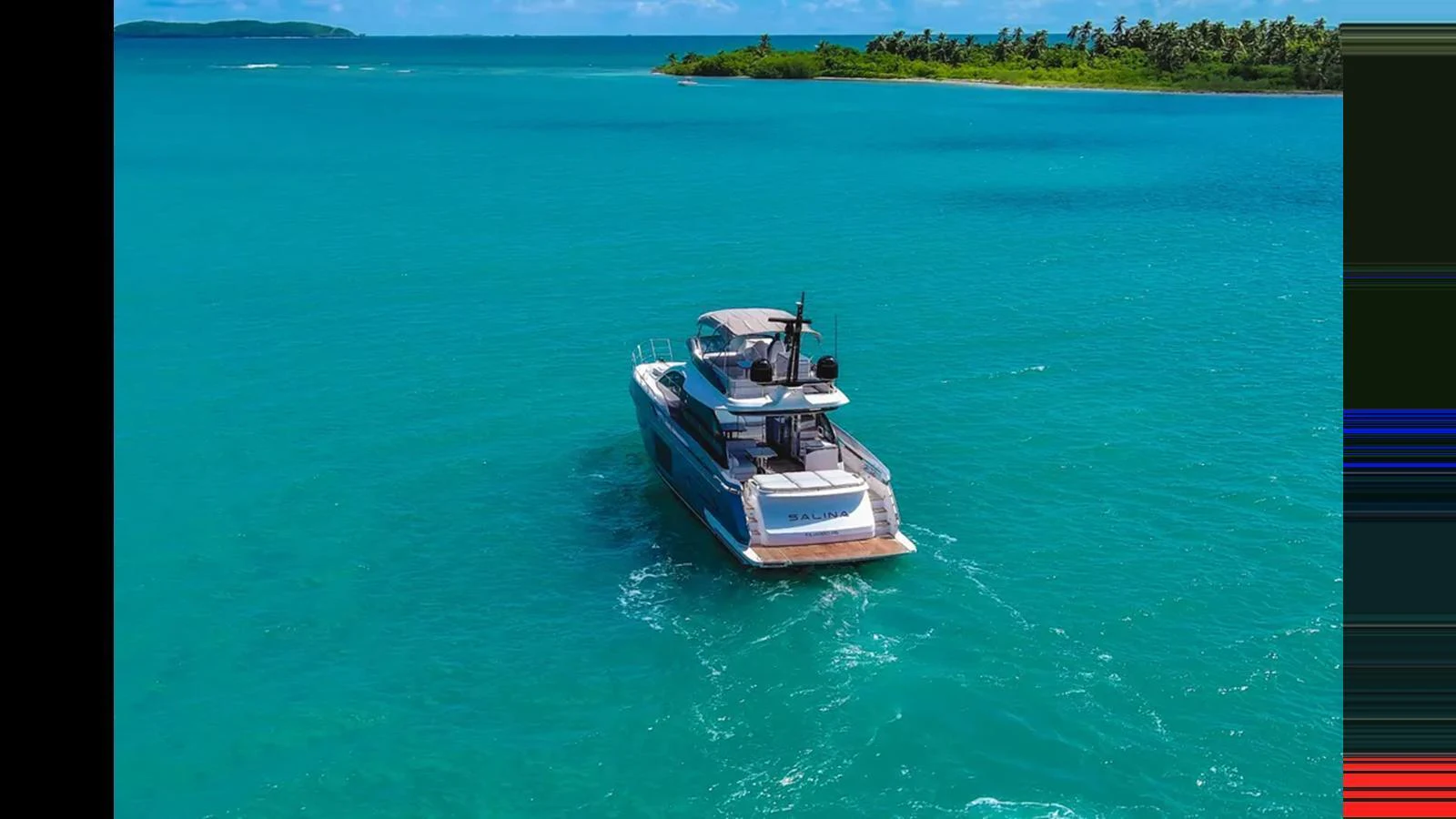 A sleek yacht cruises through vibrant turquoise waters near a lush, green island. aboard AZIMUT S7 Yacht for Sale