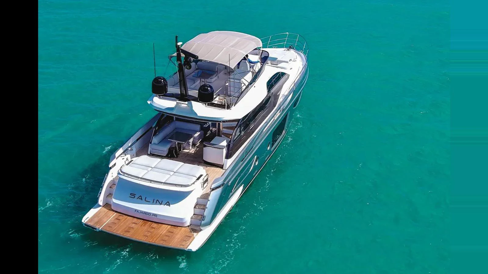 A sleek yacht cruises through turquoise waters, showcasing its spacious aft deck and modern design. aboard AZIMUT S7 Yacht for Sale