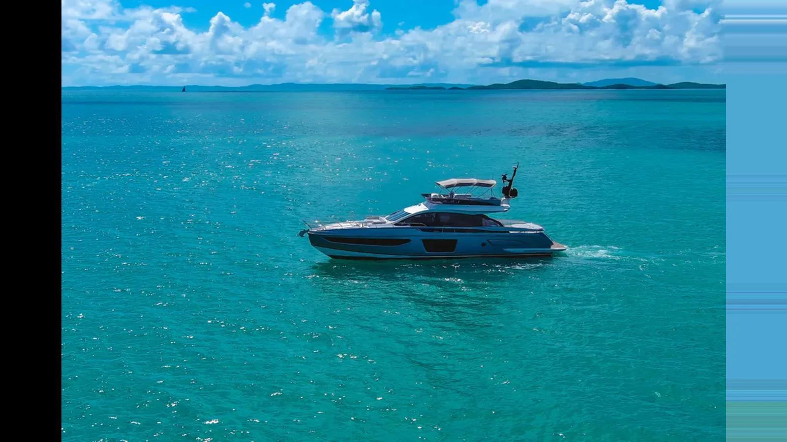A sleek yacht cruises through crystal-clear turquoise waters under a bright blue sky. aboard AZIMUT S7 Yacht for Sale