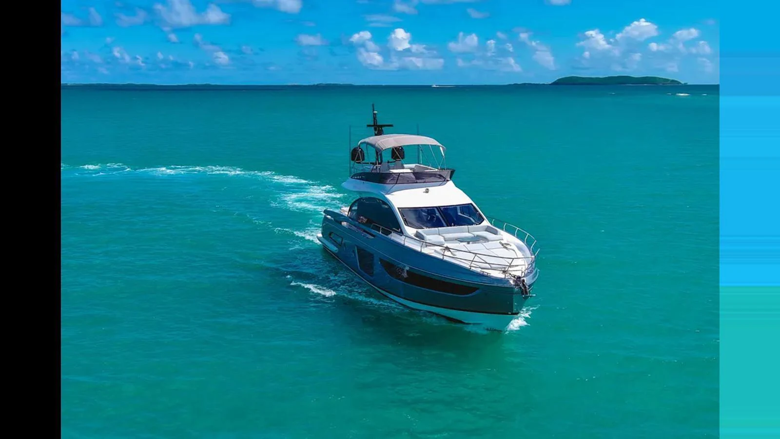 A sleek yacht cruising through clear turquoise waters under a bright blue sky. aboard AZIMUT S7 Yacht for Sale