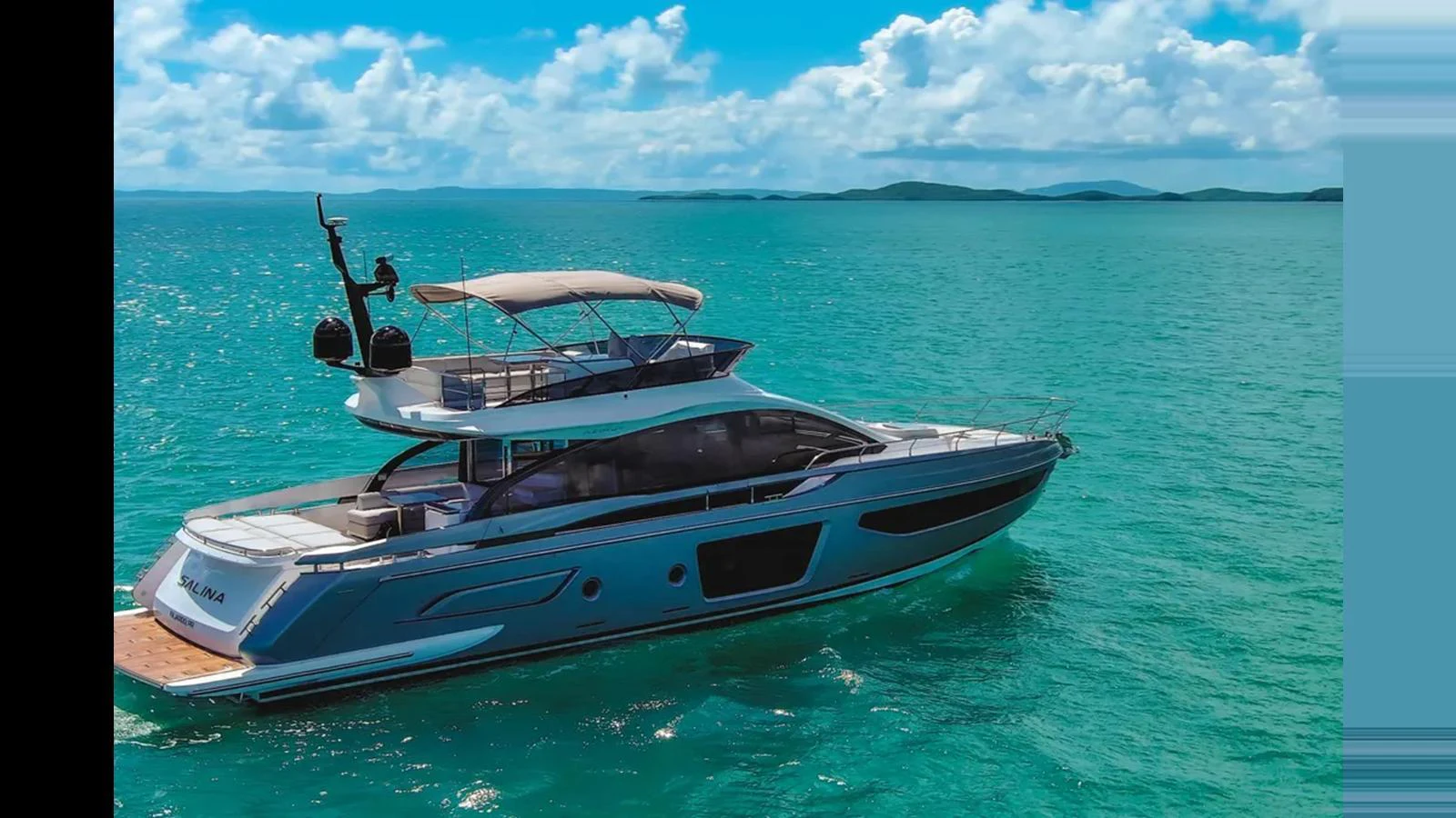A sleek yacht glides through turquoise waters under a bright blue sky. aboard AZIMUT S7 Yacht for Sale