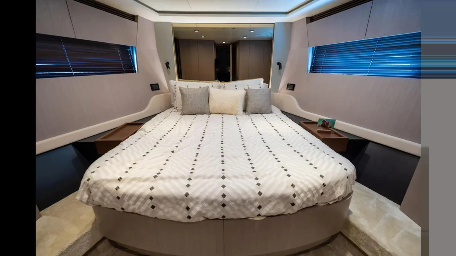 The master stateroom features a luxurious bed with elegant decor and ample natural light. aboard AZIMUT S7 Yacht for Sale