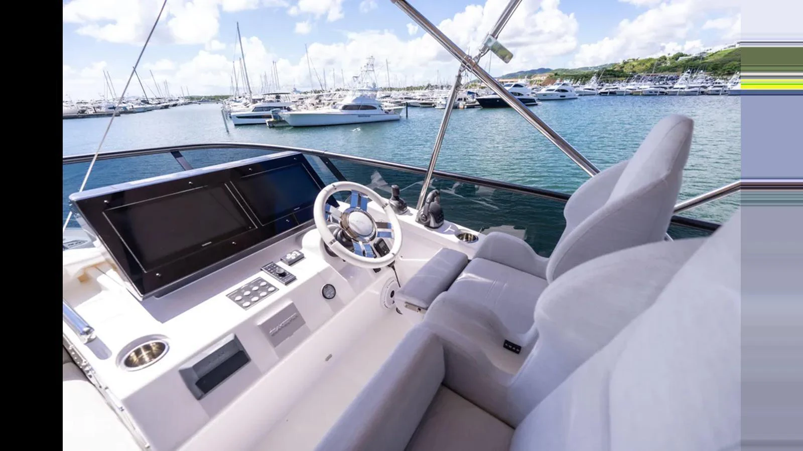 The helm station offers a commanding view with state-of-the-art navigation equipment and comfortable seating. aboard AZIMUT S7 Yacht for Sale