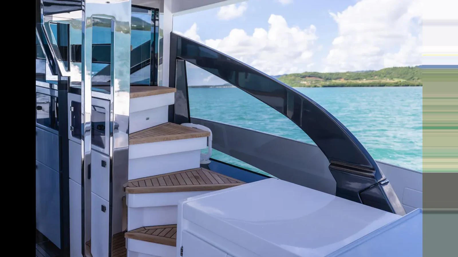 The aft deck features sleek stairs leading to the upper deck, with a stunning view of the water. aboard AZIMUT S7 Yacht for Sale